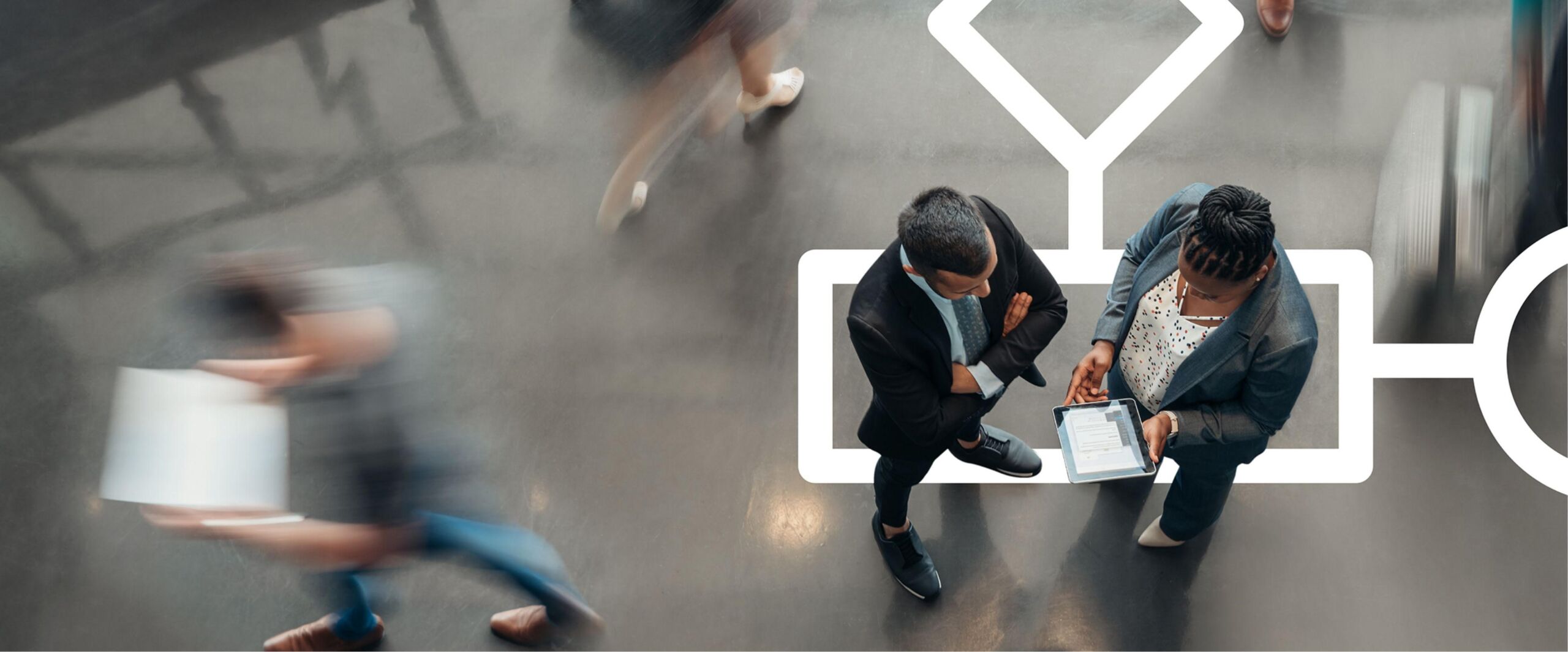 Business man and woman looking at tablet inside office