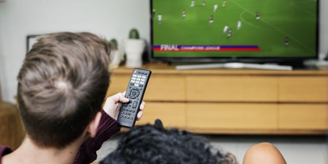 Couple watching a football game on TV